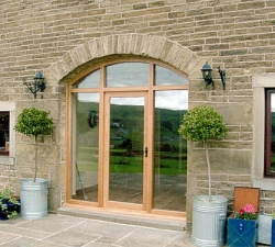 An arched barn door and windows built in solid Oak