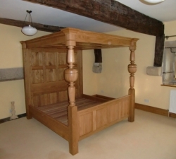 An impressive Super King Sized four poster bed built in solid Oak, featuring hand-turned bed posts created to the clients specific design. 
