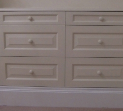 A fitted drawer unit incorporating open shelves. Hand painted in Farrow and Ball paint with White contrasting skirting