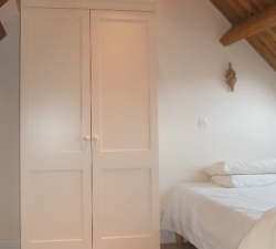 A hand painted, free standing wardrobe in a simple Shaker Style