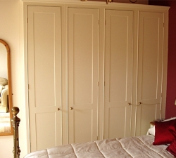 A traditional Shaker style,hand-painted, built in wardrobes.