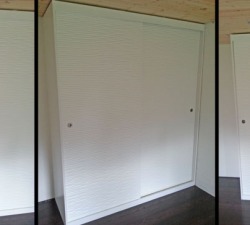 CNC-Cut Textured Wood forms the sliding wardrobe doors for this contemporary wardrobe. Designed specifically to store the clients collection of shoes.  Solid Oak drawers with dovetail joints provide contrast.