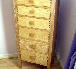 Tall, thin Ash Drawer unit. Ash drawer unit featuring dovetail joints and tapered legs. The drawers are smaller at the top of the unit for storing small items and become deeper towards the bottom. The square handles increase in size proportionally with the drawers, completing the overall design. Built for a client in Saltaire, West Yorkshire