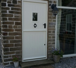 Iroko External Stable Door featuring panelled, double skinned base, viewing window & Kirkpatrick door furniture