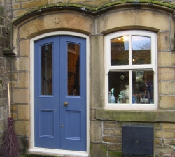An arched hardwood, double door & frame together with a mock sash window