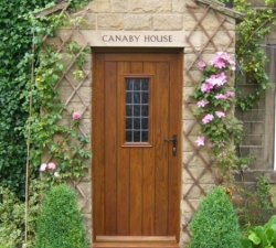 A set of two, panelled solid Oak doors for the front & rear of a property. New front door and back door both with viewing windows
