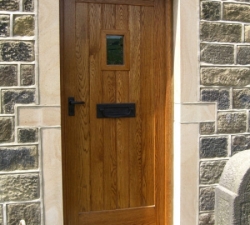 A solid Oak, panelled door  with  viewing window. Oiled finish