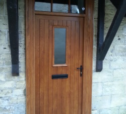 A panelled solid Oak wood door with extra deep Victorian style architrave & large viewing window.