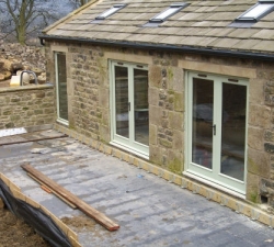 A range of solid wood doors, patio doors & arched windows for a barn conversion in a conservation area. All hand painted in historic National Trust Aloe Green
