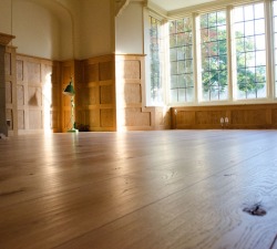 Rustic Solid Oak flooring, secretly nailed. Laid prior to fitting the Pippy Oak panelling
