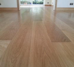 Prime American wide oak boards, finished with three coats of hard wearing Traffic.  The floor is secretly nailed and is fitted with matching architraves and skirting