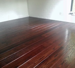 Dark Solid Oak Wood Flooring This solid Oak flooring was pre-finished by hand prior to fitting.  It was double stained to achieve the deep rich colouring.