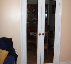 Hardwood internal doors with clear glass panels built into an opening between a kitchen and front room. Fitted in a flat in Saltaire, West Yorkshire