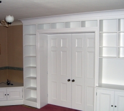 Designed to make the best use of space available, an array of hand-painted shelves and storage units were built around these hand-built, folding doors. A great example of space being utilised to its maximum potential