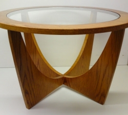 Oak retro table with Round Table Top. A veneered Oak, retro round table with safety glass top, incorporating semi circular leg design