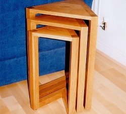 Solid Oak Nest of Tables. A set of thee Solid Oak nest of tables, each decreasing in size. Built with triangular shaped top which is mirrored at the base to form the sturdy legs